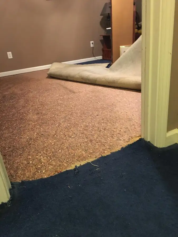 Carpet pad removal revealing water damage during Water Mitigation Services in Glendora